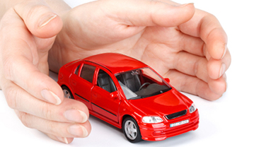 Hands wrapped around a red sedan with a white background 